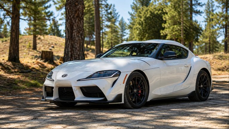 White Toyota GR Supra sports car parked on forest dirt road