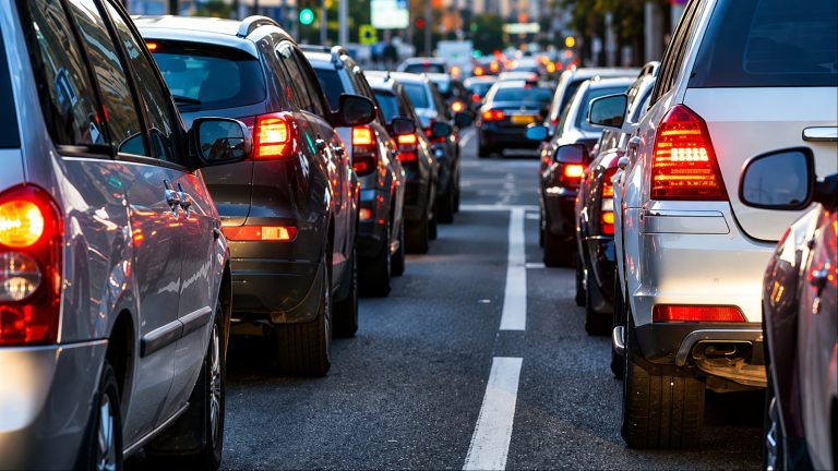 Rows of cars stopped bumper to bumper in city rush-hour traffic
