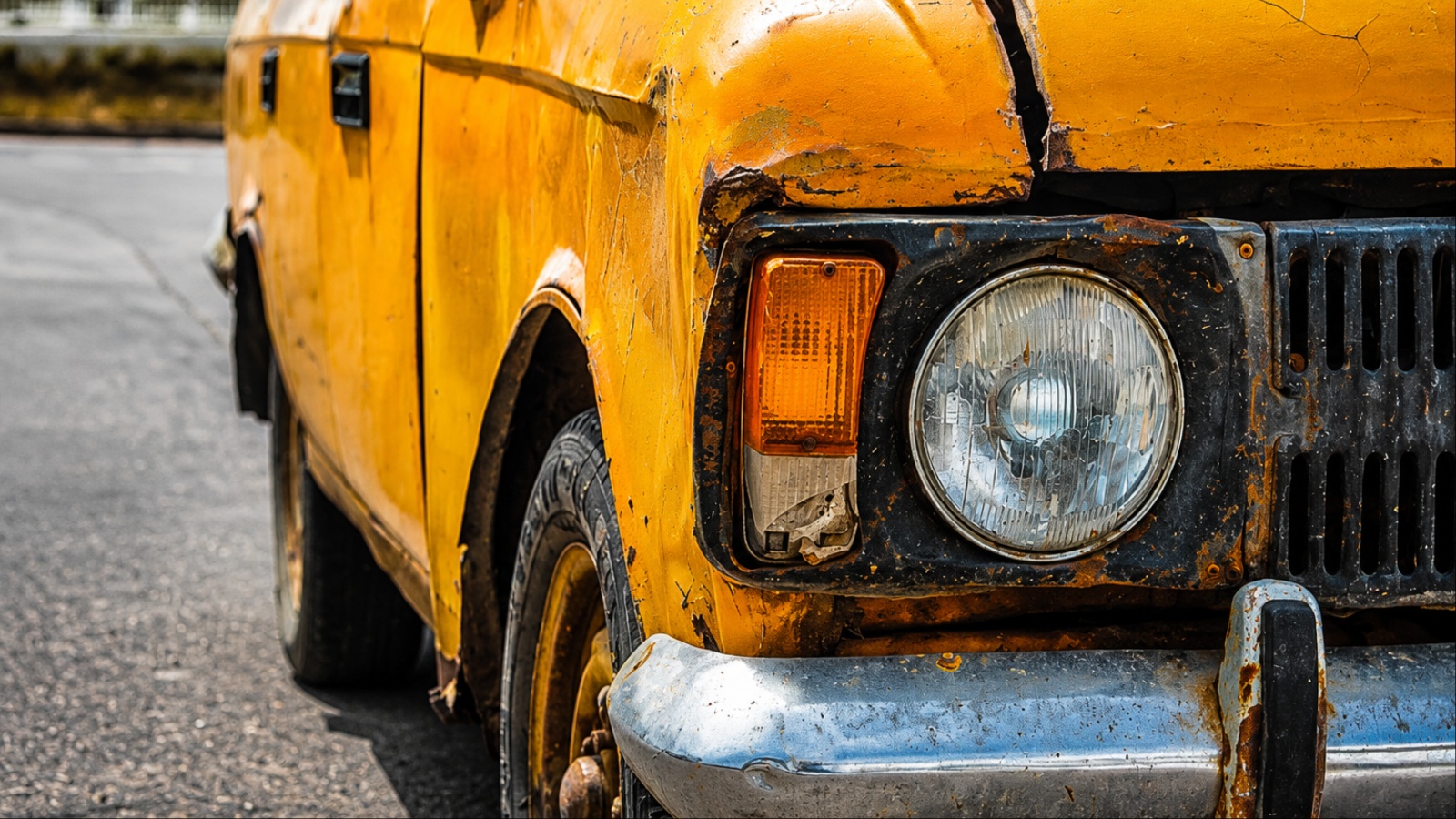 A yellow car is shown with salt damage