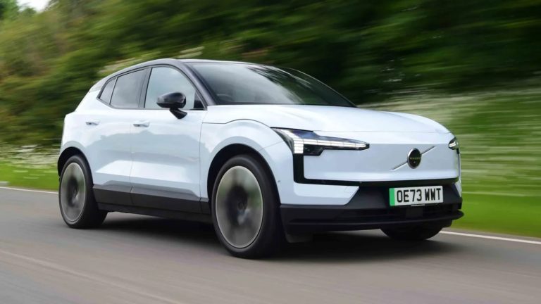 volvo ex30 electric suv cruising on a tree lined highway