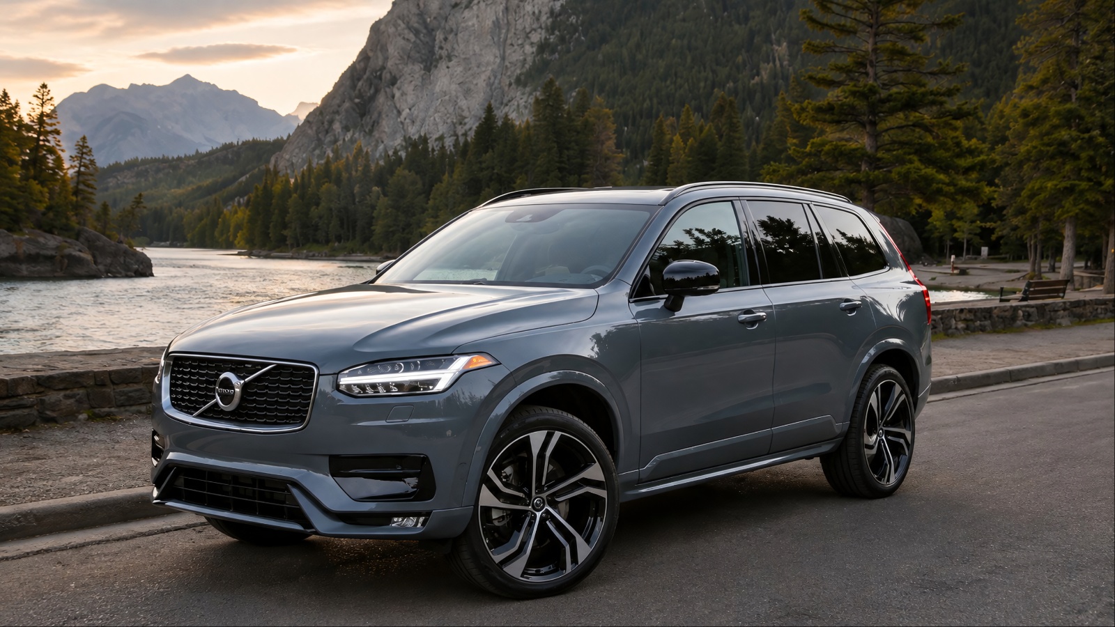Volvo XC90 parked near a mountain lake with a scenic forest backdrop