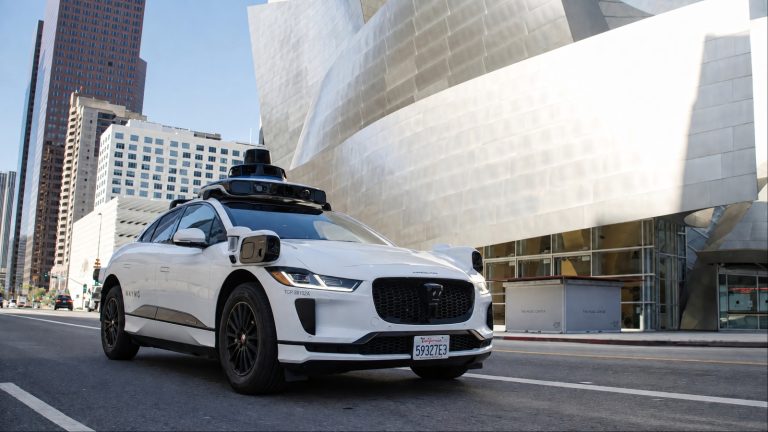 Waymo robotaxi operating on city streets, highlighting autonomous driving technology