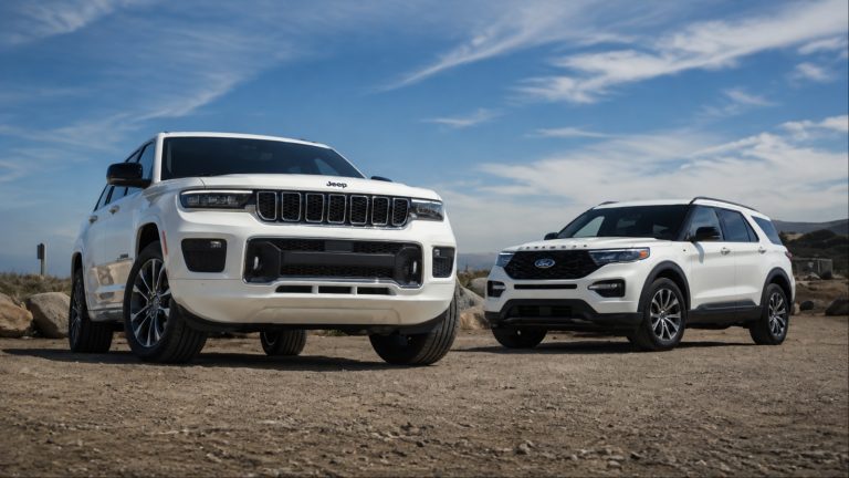 White Jeep Grand Cherokee and Ford Explorer SUVs parked outdoors