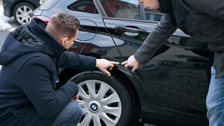 Inspecting Scratches On Used Car