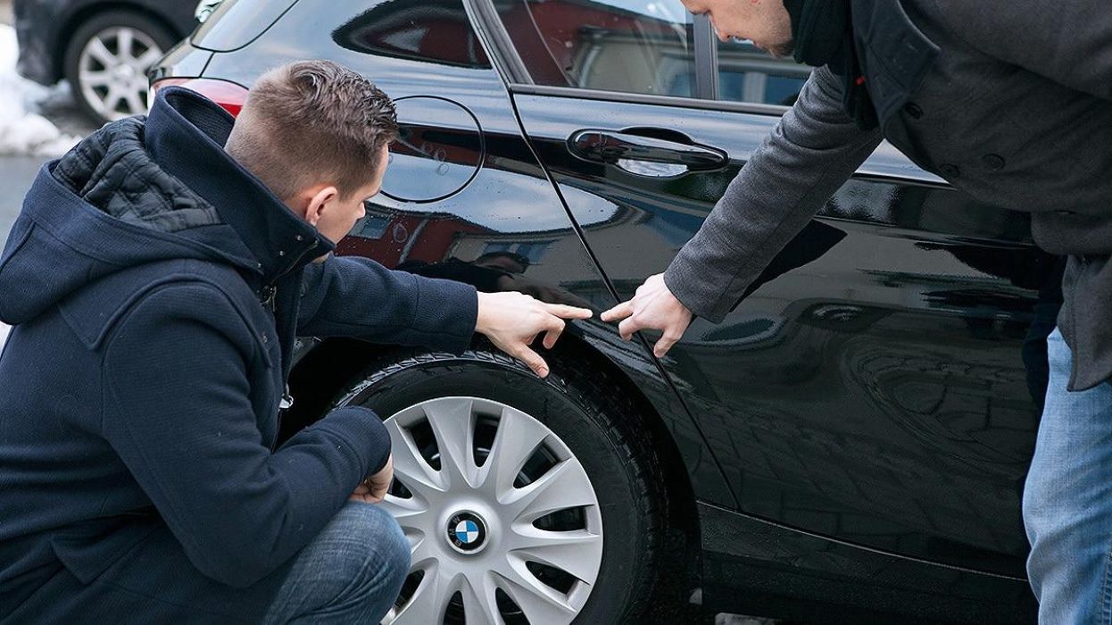 Inspecting Scratches On Used Car