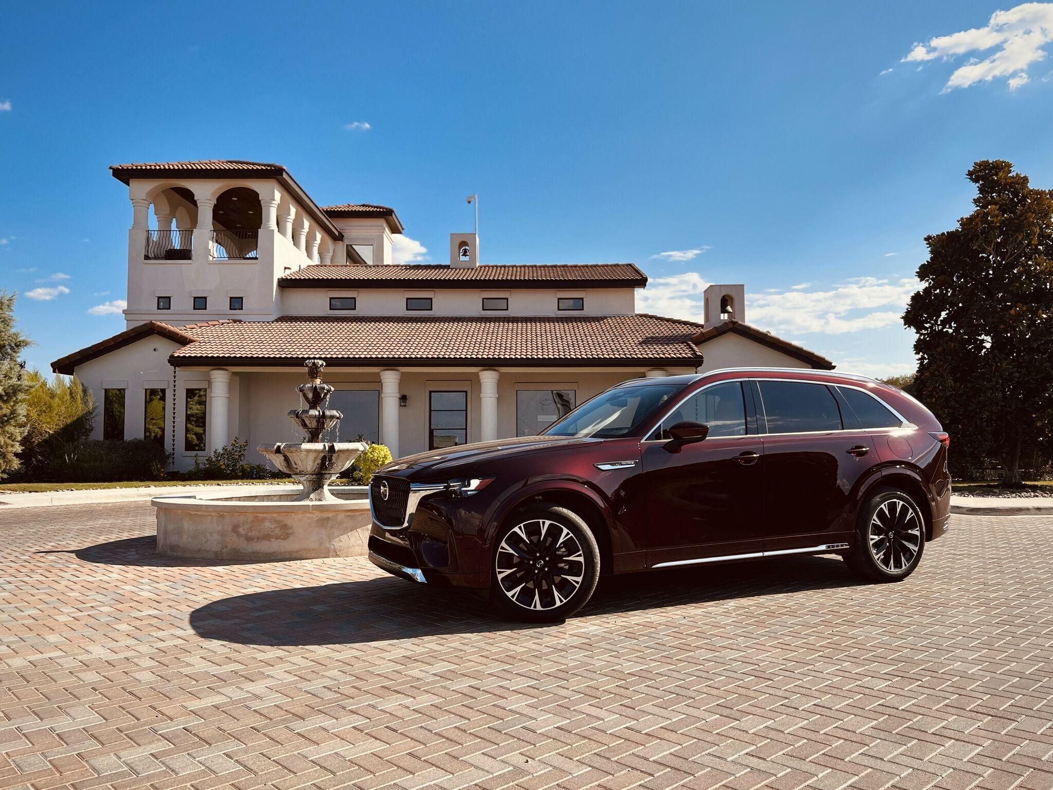 Luxury-looking SUV outside upscale mansion