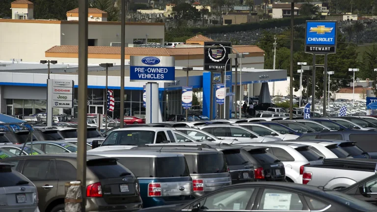 Many pre-owned cars are standing in a dealership