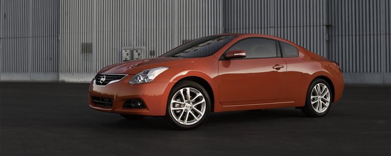 A Nissan Altima sis standing in a closed space, an under parking
