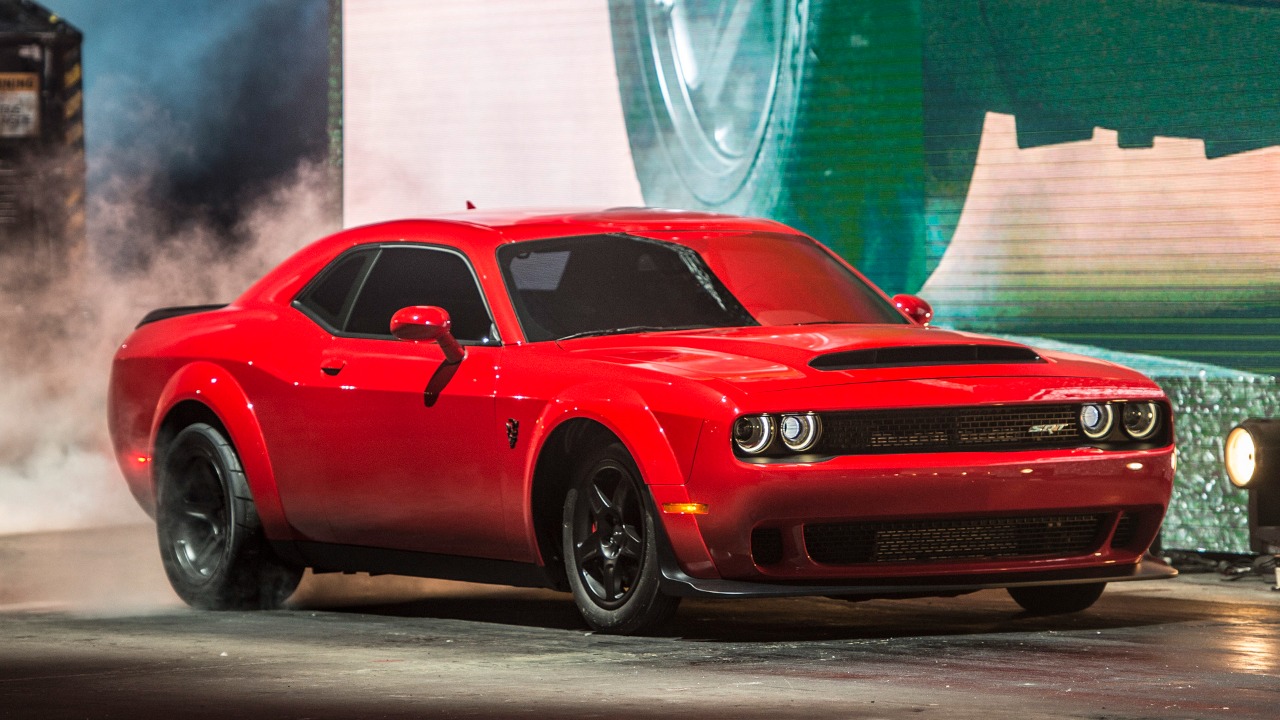 2018 Dodge Challenger SRT Demon staged under dramatic lights, showcasing its widebody stance