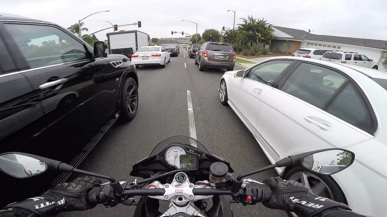 Motorcyclist lane filtering through traffic