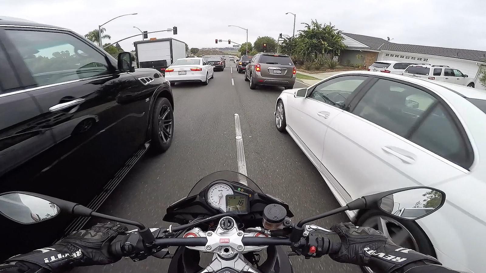 Motorcyclist lane filtering through traffic