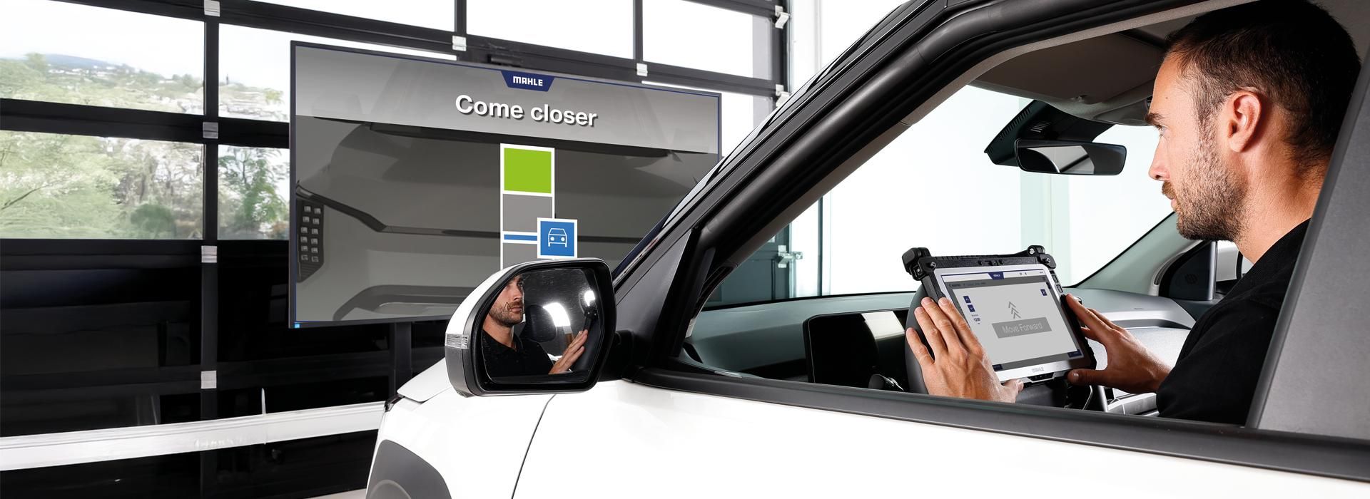 Technician calibrating advanced vehicle mirror