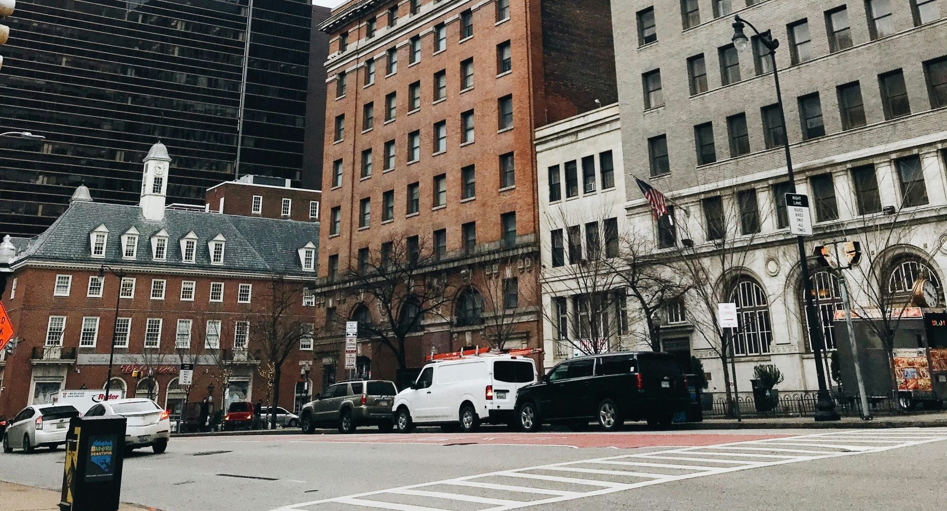 A city street is shown with cars