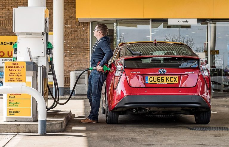 Toyota Prius hybrid refueling at station highlighting affordable ownership costs