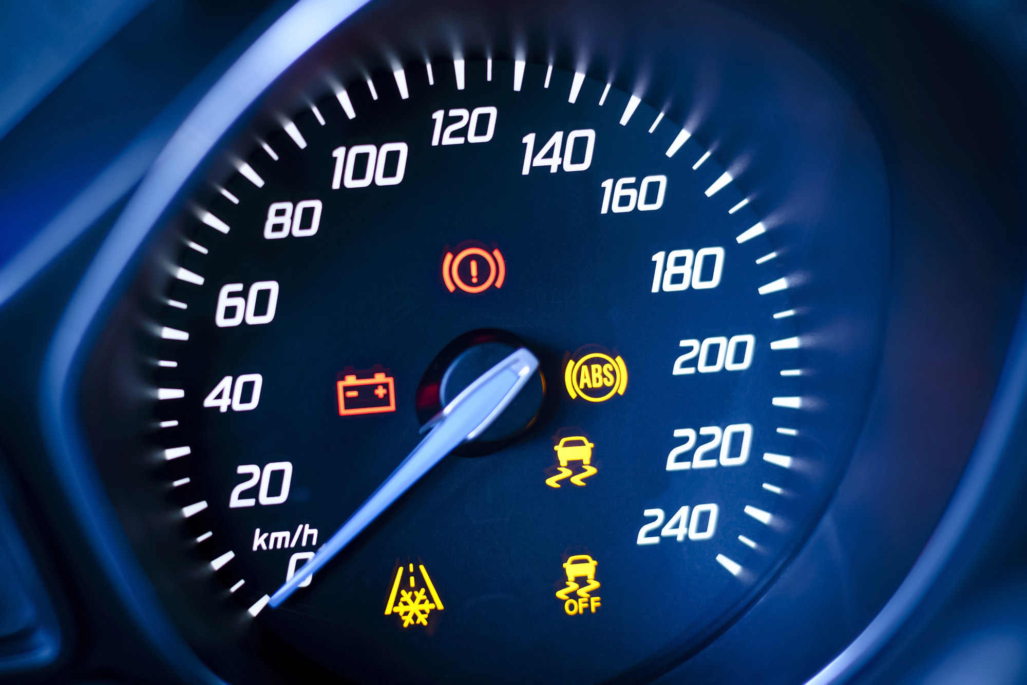 Car dashboard speedometer with multiple warning lights