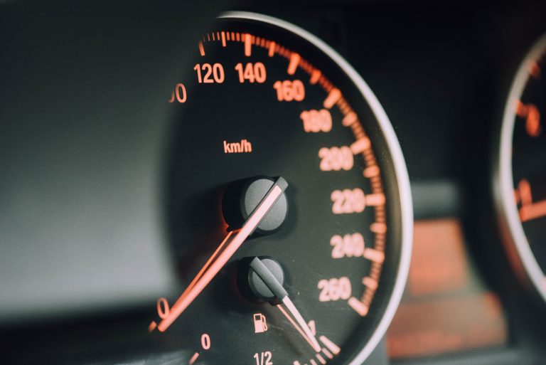 Car's speedometer reading just over 100 kilometers per hour