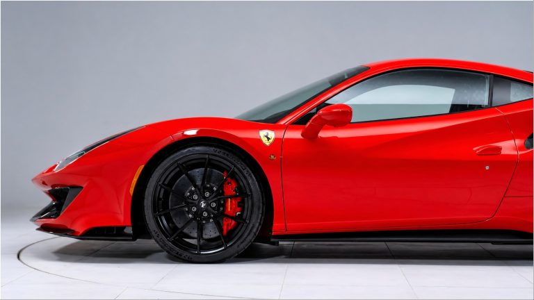 Bright red Ferrari 488 GTB side view with black rims