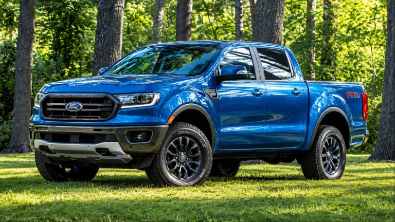 Blue Ford Ranger FX4 pickup truck parked on grassy forest