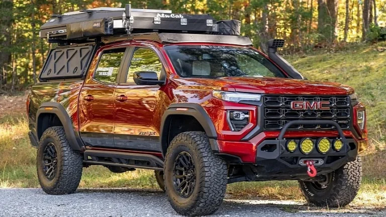 A GMC Canyon is standing in a forest oad