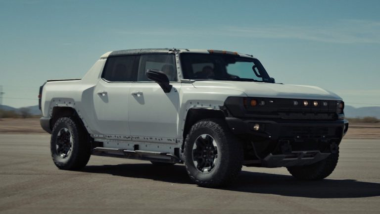 A GMC HUMMER EV is standing on a runway