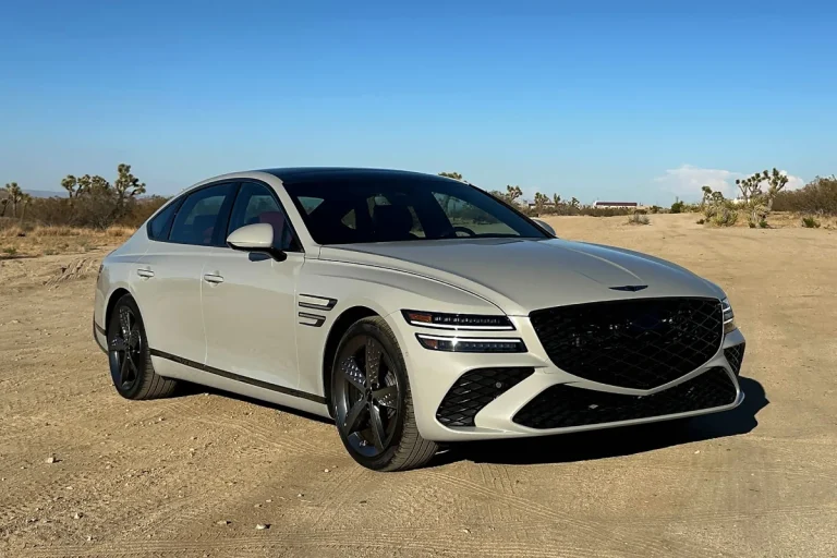 A Genesis 80 is standing still on a rough patch of a road