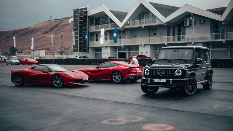 Luxury cars are standing on a local street
