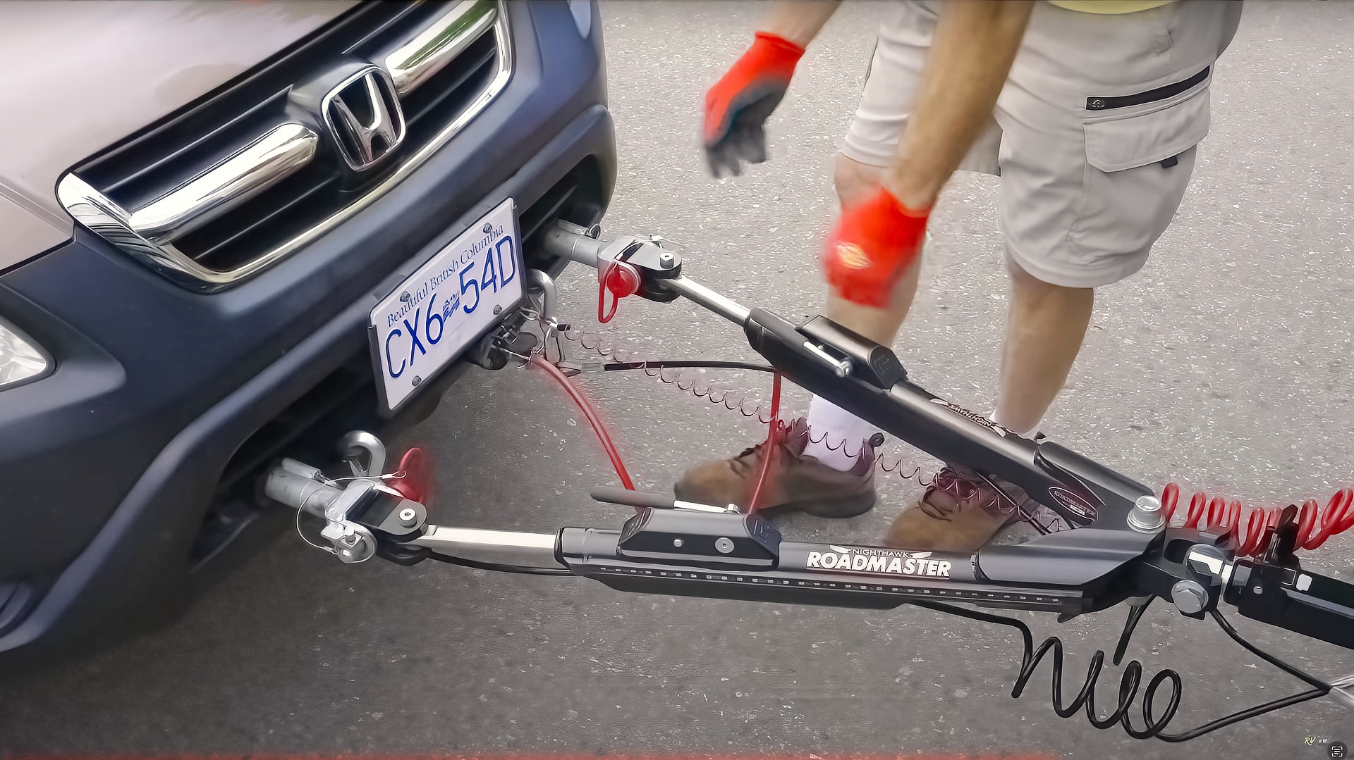 Honda CR-V being prepared for flat towing using a Roadmaster tow bar