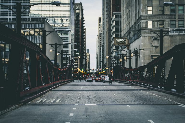 A street road is surrounded by skyscrapers in Illinois