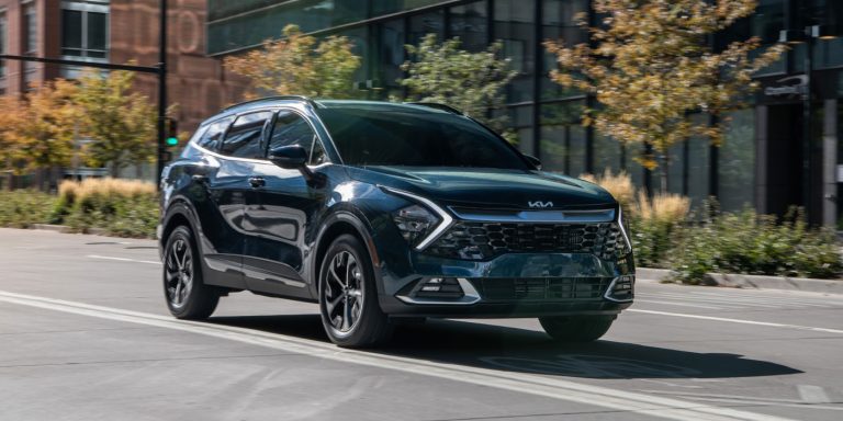 A Kia Sportage sis cruising on a highway