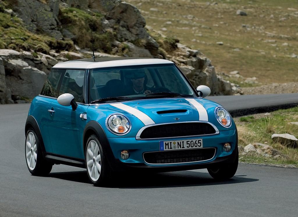 A Mini is cruising on a hilly road
