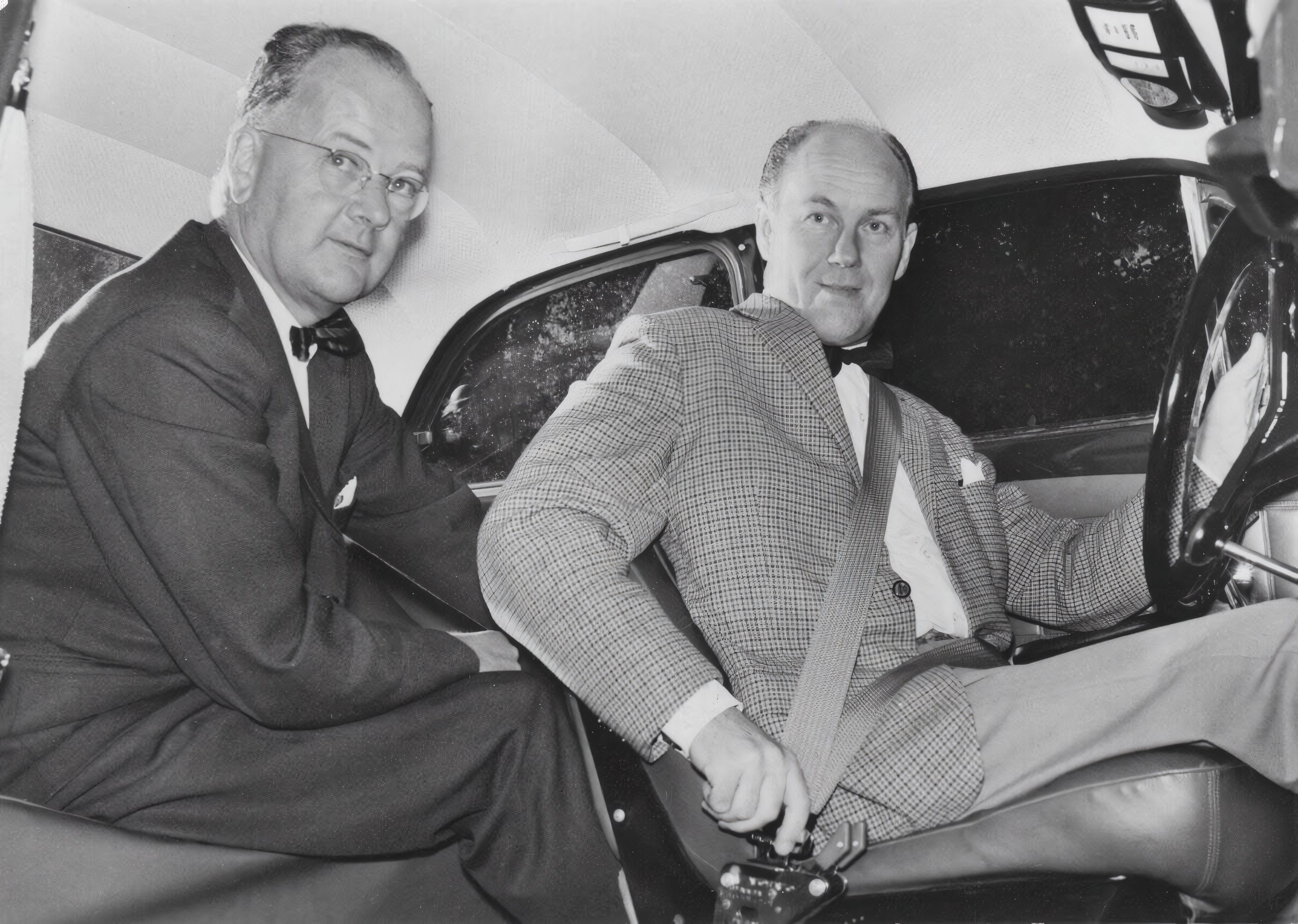 Nils Bohlin seated in a car alongside a colleague
