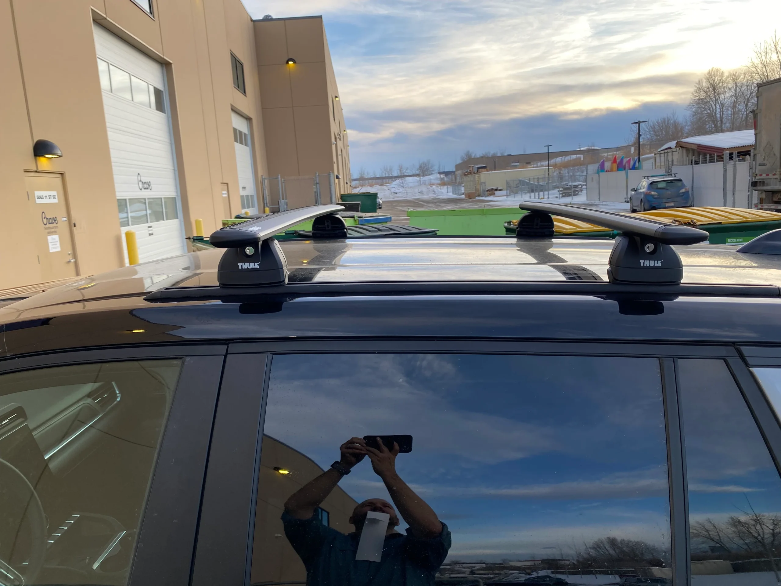 A black car is shown with roof rails