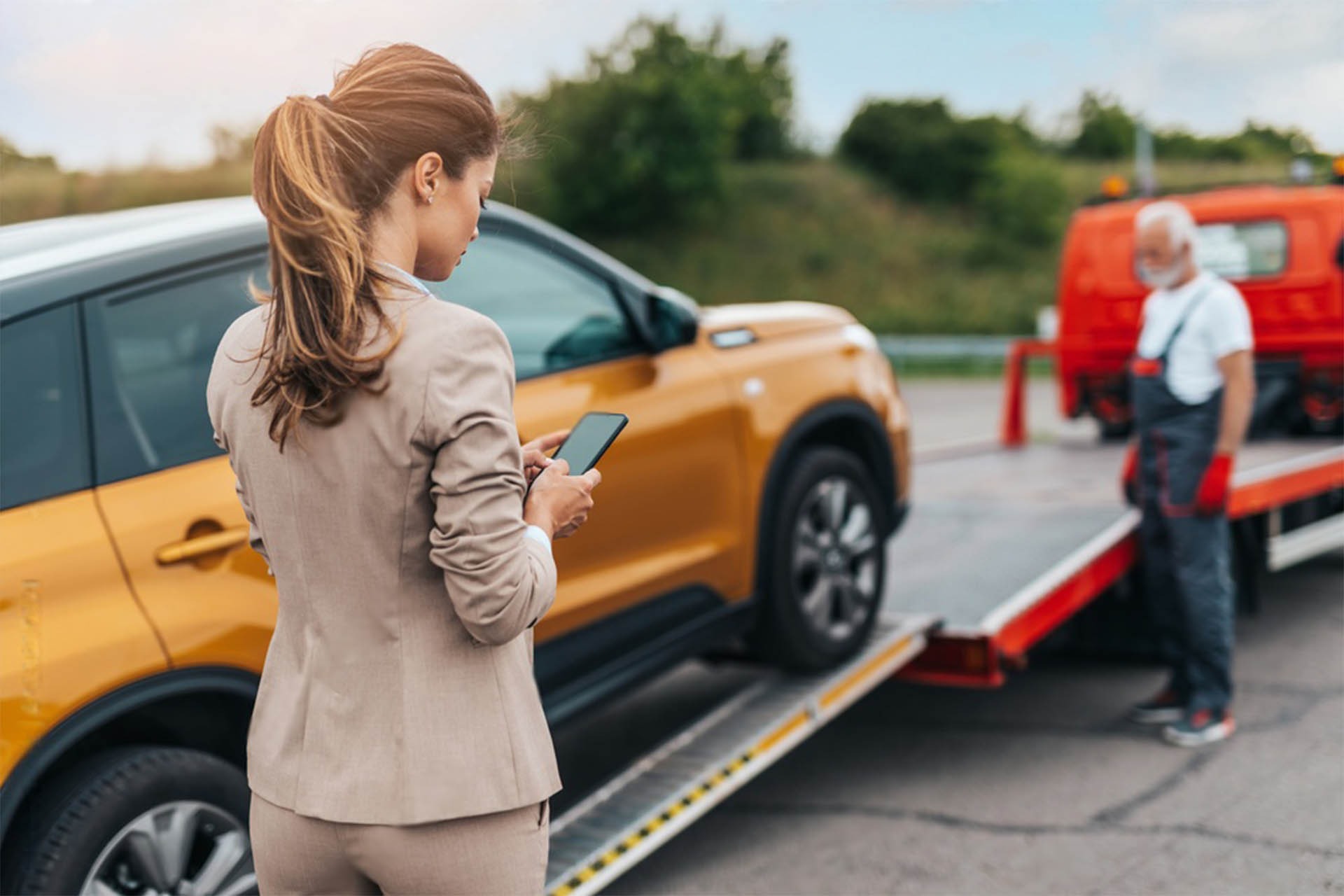 SUV being loaded onto a flatbed tow truck