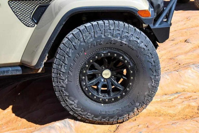A well stacked tire is shown in the image with a jeep