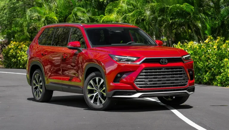 A red Toyota is standing on a car parking