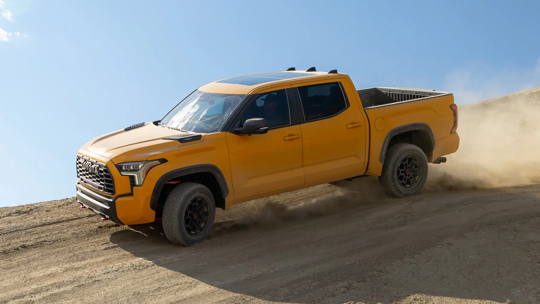 A Toyota Tundra is off roading on a hilly desert