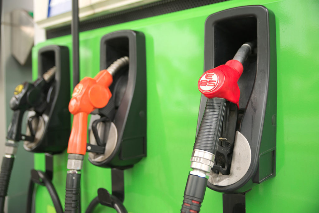 Gas pump nozzles including red E85 handle on green pump