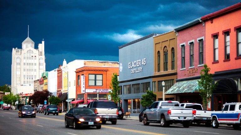 A busy Oregon downtown street lined with colorful historic buildings and traffic