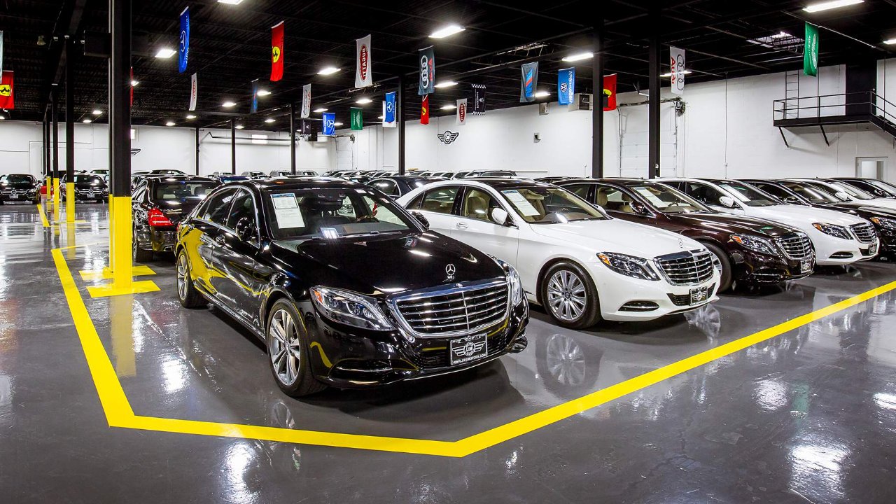 A luxury auto showroom displays rows of premium Mercedes-Benz vehicles indoors