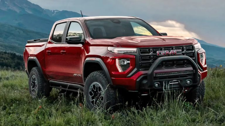 A rugged GMC Canyon pickup sits boldly against a mountain landscape
