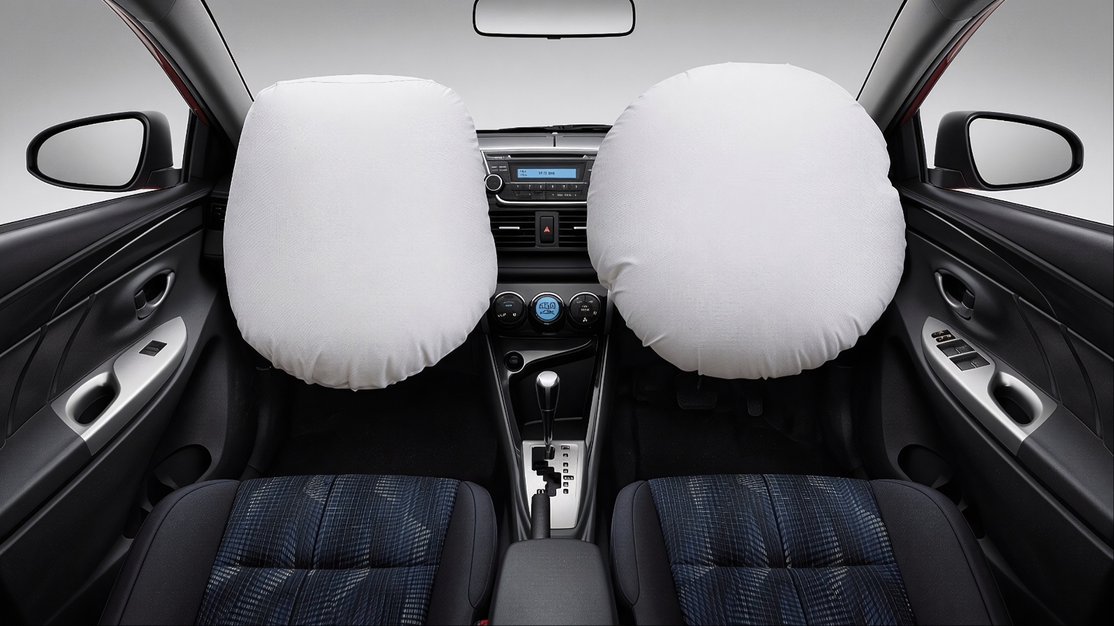 Front view of car with two white airbags fully deployed