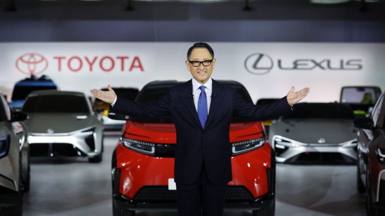 Akio Toyoda presents new vehicles at an indoor Toyota and Lexus automotive showcase