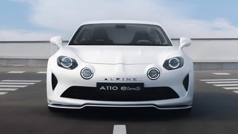 Alpine A110 sports car photographed head-on on an open rooftop roadway