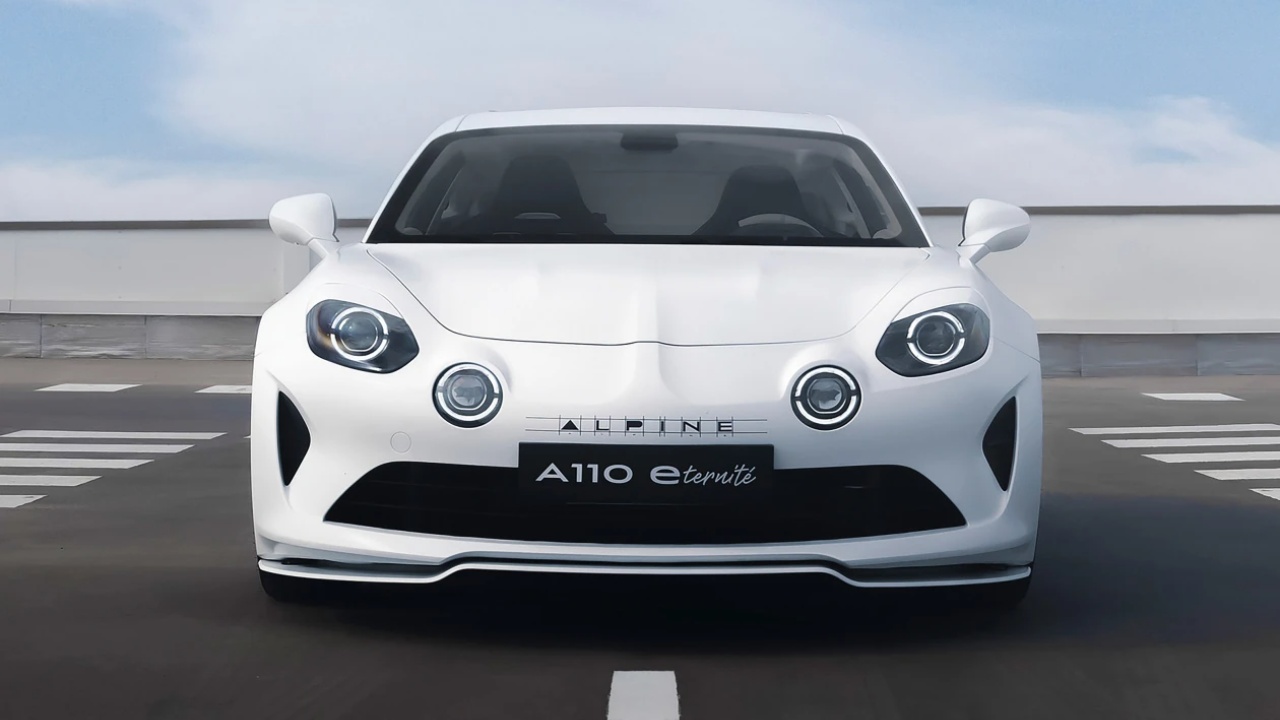 Alpine A110 sports car photographed head-on on an open rooftop roadway