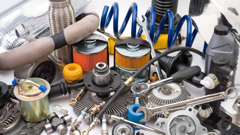 Assorted automotive parts and tools arranged together for vehicle maintenance and repairs