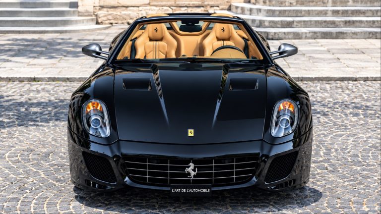 Black Ferrari 599 SA Aperta showcasing its open-top design and luxurious tan interior