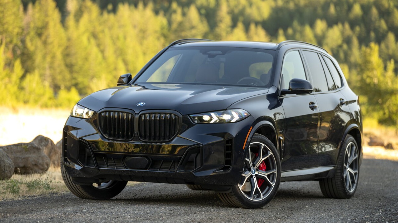BMW X5 SUV parked on a scenic forest road, highlighting its bold and luxurious design