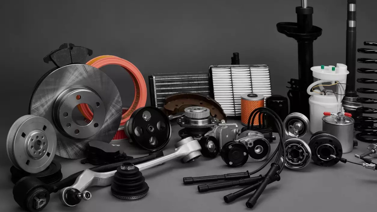Car parts and replacement components arranged against a dark background