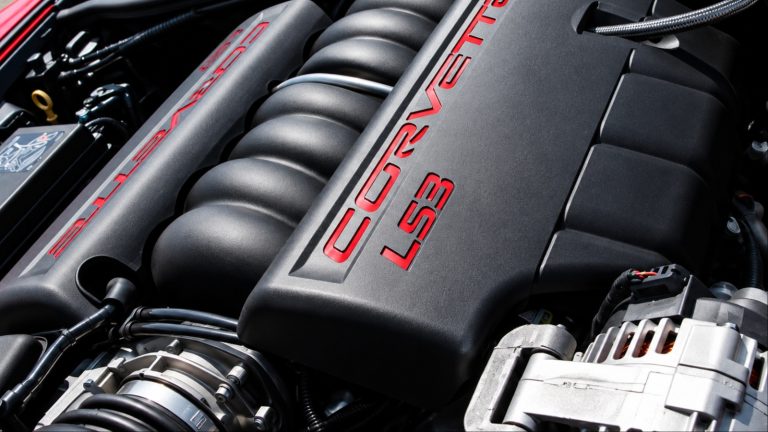 Close-up of black Corvette LS3 V8 engine cover with red logos