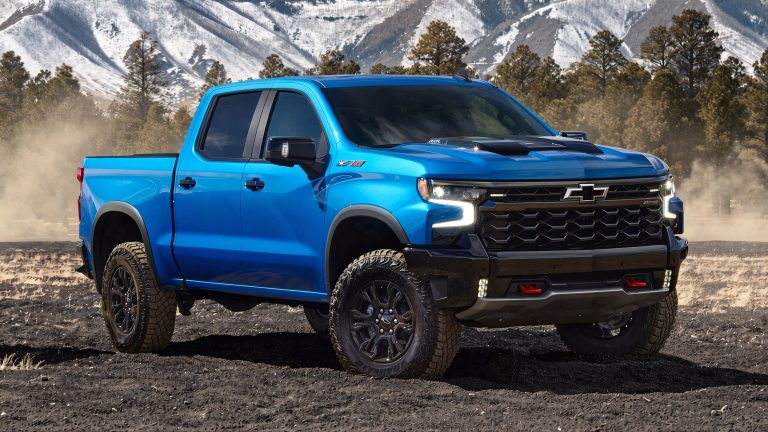 Chevrolet Silverado 1500 pickup truck parked on rugged terrain near mountains